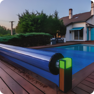 Backyard pool with a blue retractable cover rolled at the edge and a modern house with a teal awning in the background.